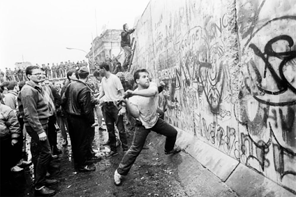 A old photography of protests at the Berlin Wall in Germany