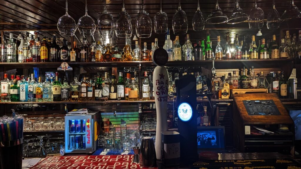 Cozy bar atmosphere at Chaba's Jazz Rock Cafe in Tbilisi with a view of the drinks menu and the warm light.