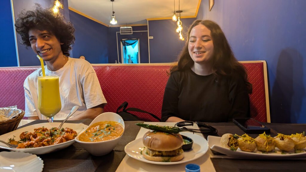 a couple enjoying plenty of food inside masala library restaurant